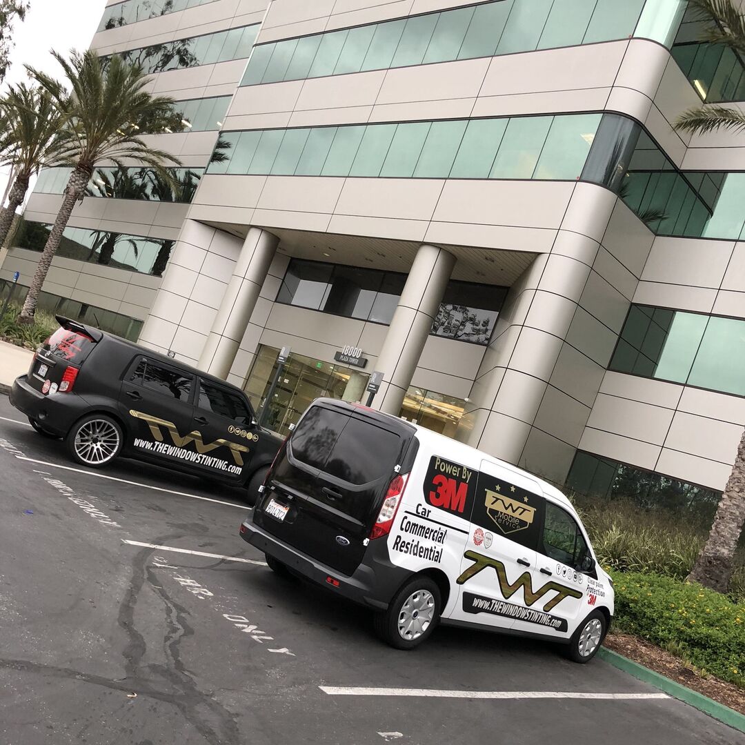 TWT company cars parked in front of a building